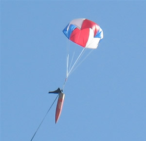 Rocket descending with parachute deployed